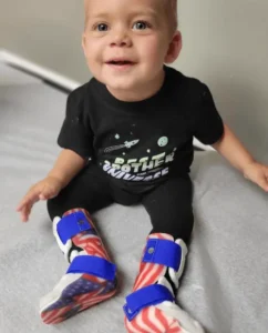 Child wearing lower extremity orthotics