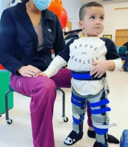 Child in lower extremity orthotics