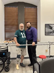Man with lower extremity prosthetic in an Eagles jersey
