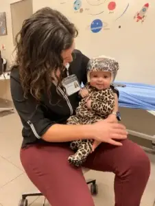 Infant wearing a cranial molding helmet