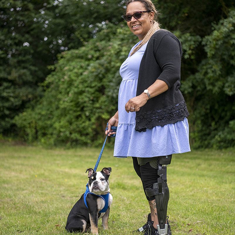 Woman wearing tectus walking dog